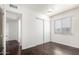 Bedroom showcasing sliding closet doors, hardwood floors, and a window with natural light at 4743 N 26Th Ln, Phoenix, AZ 85017