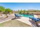 Relaxing backyard featuring a refreshing pool, comfortable lounge chairs, and a cozy fire pit area at 4836 S Covalent Ln, Mesa, AZ 85212