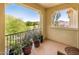 Balcony with outdoor seating and vibrant potted plants offering scenic community views at 4836 S Covalent Ln, Mesa, AZ 85212