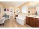 Luxurious bathroom with a soaking tub, dual vanities, and elegant fixtures at 4836 S Covalent Ln, Mesa, AZ 85212