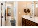 A bright bathroom vanity with tile flooring and archway entrance, provides a functional and clean design at 4836 S Covalent Ln, Mesa, AZ 85212