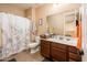 Bathroom featuring a single vanity, dark wood cabinetry, and tiled shower and floors at 4836 S Covalent Ln, Mesa, AZ 85212