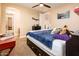A bright bedroom with an archway entrance, ceiling fan, and natural light creates an open, airy space at 4836 S Covalent Ln, Mesa, AZ 85212
