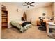 Bedroom with a bed, desk, bookshelf, guitar, and art at 4836 S Covalent Ln, Mesa, AZ 85212
