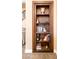 Stylish bookcase filled with books and decorative items, adjacent to the staircase at 4836 S Covalent Ln, Mesa, AZ 85212
