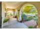 Covered front porch, featuring arched columns, has ample seating for relaxing outdoors at 4836 S Covalent Ln, Mesa, AZ 85212