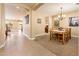 An open-concept hallway with tile flooring leads to a dining area and other living spaces, offering a bright, airy feel at 4836 S Covalent Ln, Mesa, AZ 85212