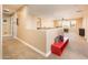 Hallway with neutral walls and carpet leading to an open living area with natural light at 4836 S Covalent Ln, Mesa, AZ 85212