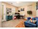 Cozy home office with a comfortable blue couch and a well-lit workspace at 4836 S Covalent Ln, Mesa, AZ 85212