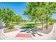 A green space with walking paths, trees, a grassy field, and neighborhood amenities at 4836 S Covalent Ln, Mesa, AZ 85212