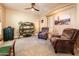 Comfortable sitting area with plush armchairs, a stylish bookshelf, and neutral décor at 4836 S Covalent Ln, Mesa, AZ 85212