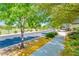 This street is lined with trees and yellow flowers, creating a vibrant and scenic environment at 4836 S Covalent Ln, Mesa, AZ 85212
