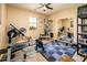 This is a workout room with exercise equipment, a ceiling fan, and a view outside the window at 4836 S Covalent Ln, Mesa, AZ 85212