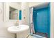 Bright bathroom features blue tiled walk-in shower at 5025 N 20Th Ave, Phoenix, AZ 85015