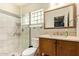 Neutral bathroom features a walk-in shower and wood vanity at 5025 N 20Th Ave, Phoenix, AZ 85015