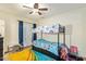 This bedroom features a ceiling fan, colorful carpet, and natural light at 5025 N 20Th Ave, Phoenix, AZ 85015