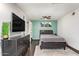 Bedroom features a television, ceiling fan, and natural light from the window at 5025 N 20Th Ave, Phoenix, AZ 85015