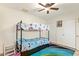 This bedroom features a bunk bed, carpet, and ceiling fan at 5025 N 20Th Ave, Phoenix, AZ 85015