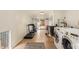 Functional laundry room with workout equipment, tiled floors, and access to the backyard, blending chores and fitness at 5025 N 20Th Ave, Phoenix, AZ 85015
