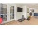 Workout area with weights, TV, access to outside, and laundry appliances, ideal for fitness and convenience at 5025 N 20Th Ave, Phoenix, AZ 85015