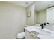 Tastefully updated half-bathroom with a marble counter, stylish black faucet, decorative art, and a plush towel at 5124 N 31St Pl # 522, Phoenix, AZ 85016