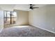 Bright bedroom with large window, neutral paint, ceiling fan and plush carpet offers a relaxing retreat at 5124 N 31St Pl # 522, Phoenix, AZ 85016