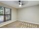 Neutral bedroom with carpet flooring, a large window, and a modern ceiling fan with light at 5124 N 31St Pl # 522, Phoenix, AZ 85016