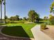Lush green golf course with mature trees, a serene pond and a sidewalk, providing a picturesque view at 5124 N 31St Pl # 522, Phoenix, AZ 85016