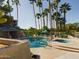 Inviting community pool surrounded by towering palm trees, a cabana, lounge chairs, and a spa at 5124 N 31St Pl # 522, Phoenix, AZ 85016