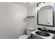 Stylish half-bathroom featuring industrial pipe fixtures and a modern vessel sink at 5621 N 79Th St, Scottsdale, AZ 85250