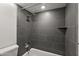 Remodeled bathroom showcasing a gray tiled shower and a white bathtub for a tranquil retreat at 5621 N 79Th St, Scottsdale, AZ 85250