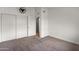 Bedroom features white walls and closet with neutral carpet at 5621 N 79Th St, Scottsdale, AZ 85250