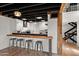 Kitchen featuring seating at the bar, beam ceilings, and stainless steel appliances at 5621 N 79Th St, Scottsdale, AZ 85250