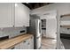 Modern kitchen with stainless steel refrigerator, butcher block counters, and white cabinetry at 5621 N 79Th St, Scottsdale, AZ 85250