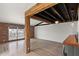 Open living space with exposed beam ceilings and a brick accent wall at 5621 N 79Th St, Scottsdale, AZ 85250