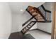Staircase with black railings and wood steps in a brightly lit area at 5621 N 79Th St, Scottsdale, AZ 85250