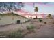 The backyard has plenty of space for outdoor activities, complemented by a vibrant sunset at 607 E Holmes Ave, Mesa, AZ 85204