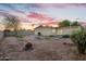 Expansive backyard offering ample space for outdoor activities, featuring a gorgeous colorful sunset at 607 E Holmes Ave, Mesa, AZ 85204