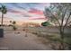 Large backyard offering space for outdoor activities, complemented by a vibrant colorful sunset at 607 E Holmes Ave, Mesa, AZ 85204