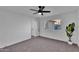 Spacious bedroom featuring a ceiling fan, neutral carpet, and a bright window at 607 E Holmes Ave, Mesa, AZ 85204
