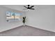 Bright bedroom featuring a ceiling fan, neutral carpet, and a bright window at 607 E Holmes Ave, Mesa, AZ 85204