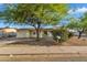 Charming single-story home with a well-manicured front yard and mature landscaping at 607 E Holmes Ave, Mesa, AZ 85204
