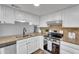Bright kitchen featuring stainless steel appliances, granite countertops and white cabinets at 607 E Holmes Ave, Mesa, AZ 85204