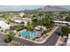 Aerial view of neighborhood pool, surrounded by palm trees and well-maintained landscaping at 6206 E Avalon Dr, Scottsdale, AZ 85251