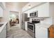Updated kitchen with stainless steel appliances, bright white cabinetry, and subway tile backsplash at 6206 E Avalon Dr, Scottsdale, AZ 85251