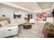 Comfortable living room featuring white leather furniture, stylish decor, and wood-look flooring at 6206 E Avalon Dr, Scottsdale, AZ 85251
