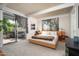 Serene main bedroom with sliding glass door, plush carpet, and backyard access at 6206 E Avalon Dr, Scottsdale, AZ 85251