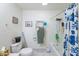 Bright bathroom showcasing a shower/tub combo, toilet, and towel rack with a blue-and-white shower curtain at 6445 W Windsor Blvd, Glendale, AZ 85301