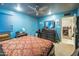 Bedroom in blue with a bed, dresser, mirror, and doorway at 6445 W Windsor Blvd, Glendale, AZ 85301