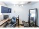 Home gym with weight bench, desk, television, and exercise equipment for fitness enthusiasts at 6445 W Windsor Blvd, Glendale, AZ 85301